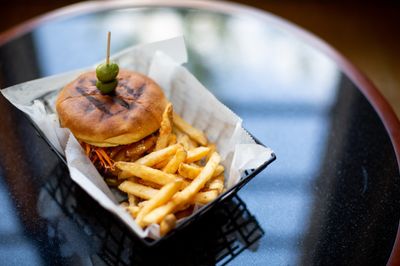 A cheeseburger with a side of fries.