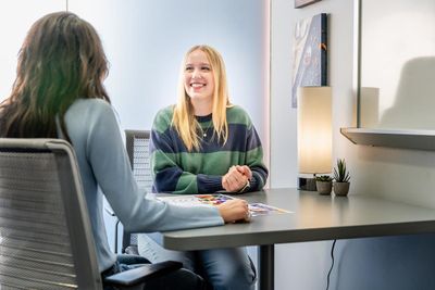 NAU students smile while working together on campus.