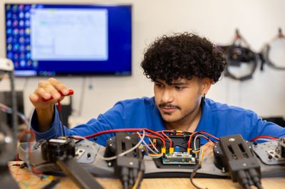 An engineering student works on a mechanical project.