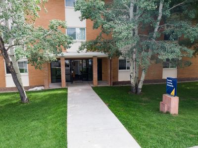 The exterior of Cowden Hall, a residential space and learning center, surrounded by trees on Flagstaff campus.