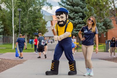 Louie the Lumberjack posing with a student volunteer on the NAU Flagstaff Campus.