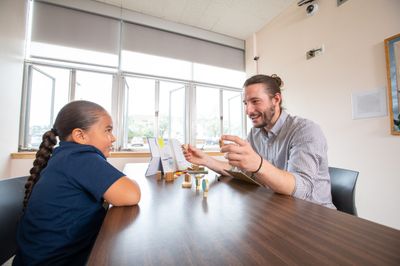 An NAU College of Education student works with a young K-12 student.