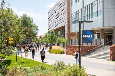 A bustling day on campus with students walking on the pedway of north campus at NAU.