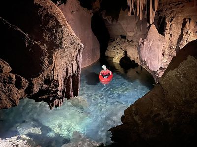 A researcher on a raft in a flooded cave in the Grand Canyon.