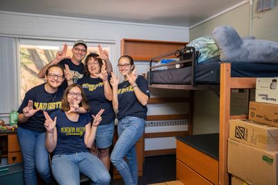 A family moves their new NAU student into the dorms on Flagstaff campus.