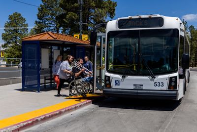NAU Shuttle picks up students at the bus stop.