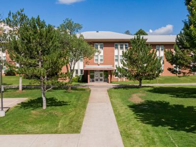The outside of Wilson Hall, a residential hall for students, on a clear summer day at NAU Flagstaff campus.