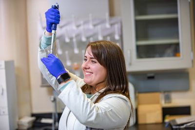 Karisma Kocos works with chemistry equipment.