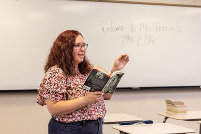 A student reads an excerpt of a book in front of the class.