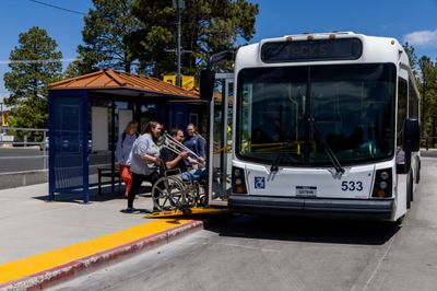 NAU Shuttle picks up students at the bus stop.