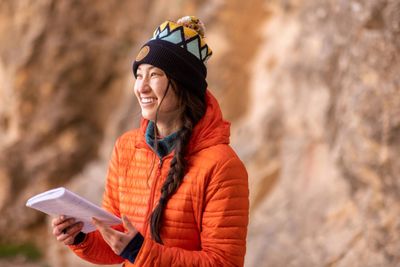 An NAU Honors College student happily performs a study with her class at the Grand Canyon.